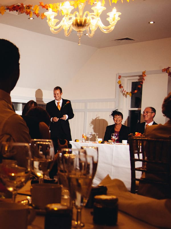 Image of a young man giving a best man's speech at a wedding