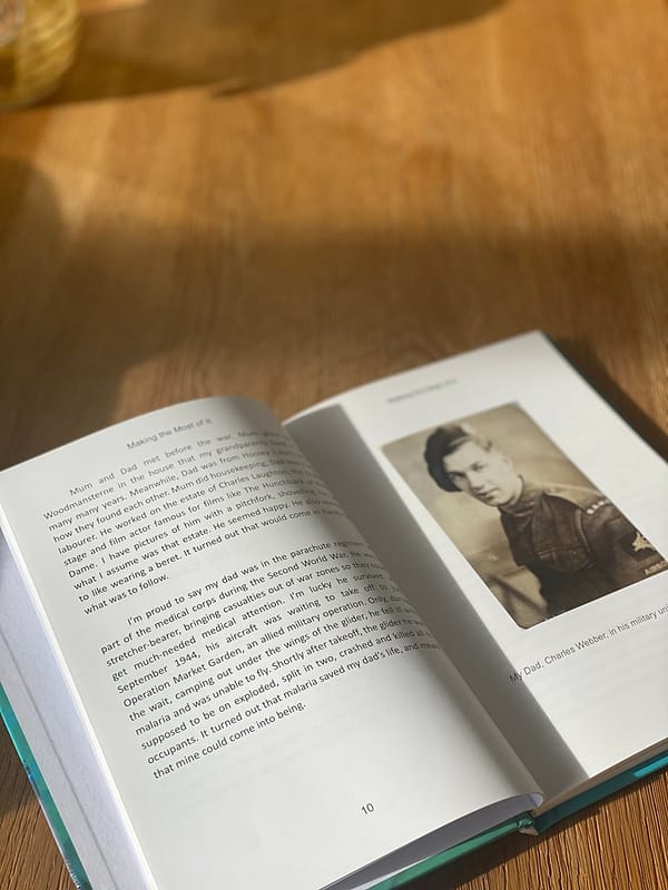 An autobiography on a table open at page 10, showing copy and images.